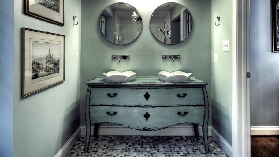 light green repurposed dresser with drawers and vessel sinks on top