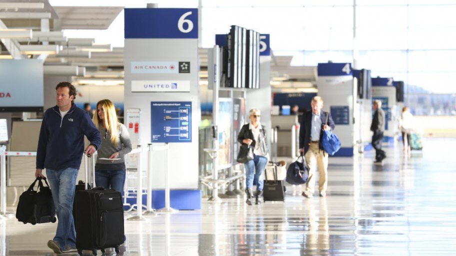 travelers at airport with luggage