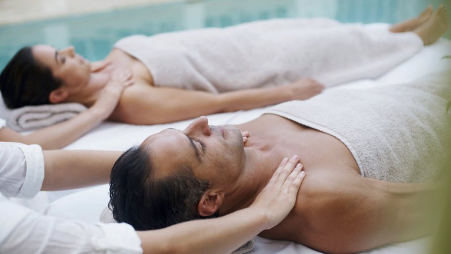 couple getting poolside massages