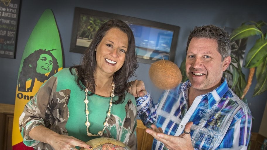 couple holding globe and tossing a coconut