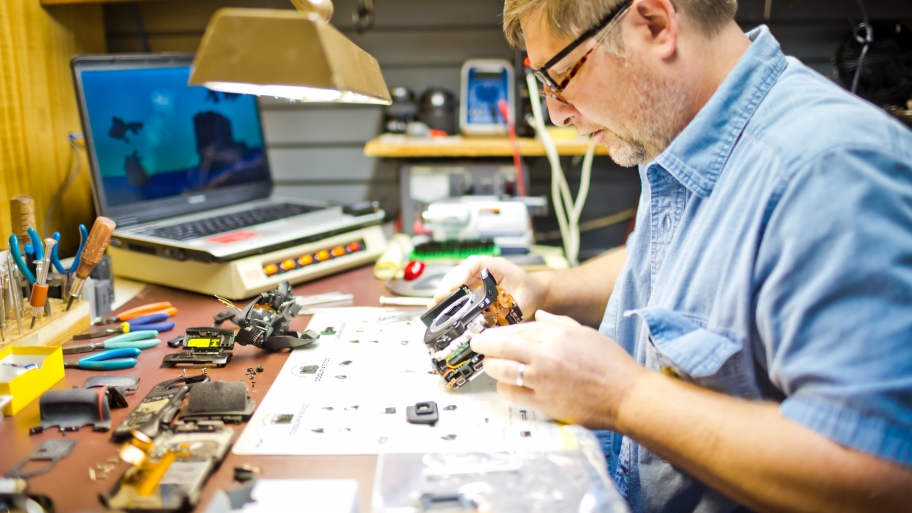 a man fixing an old camera