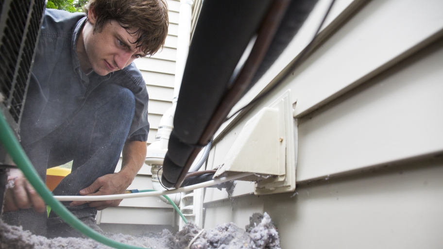 man cleaning dryer vent