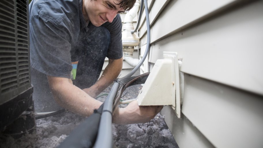 man cleaning dryer vent