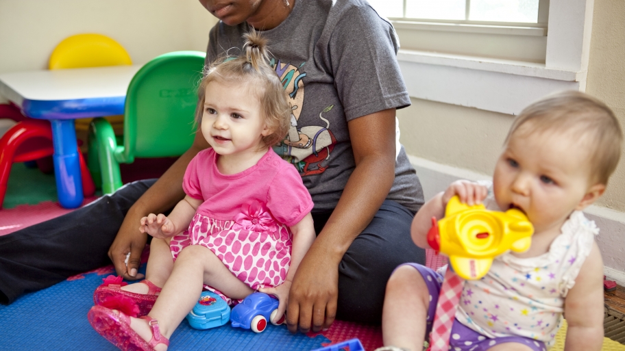 toddler and baby playing