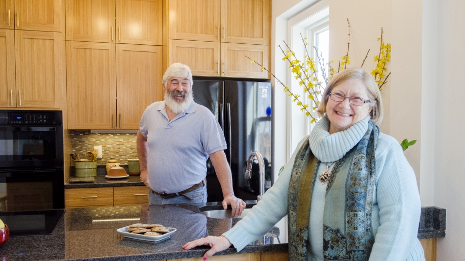 man and woman standing in kitchen