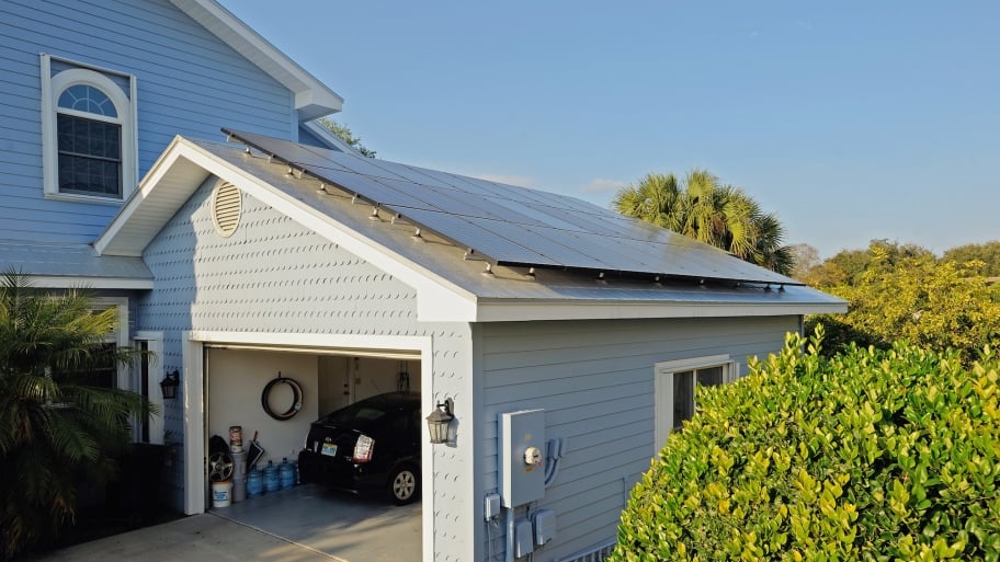 solar panels on garage with Prius inside