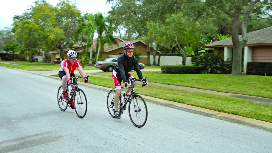 two men bicycling on road