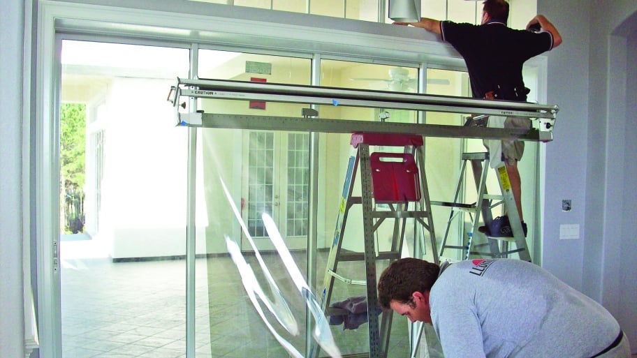 workers applying window film