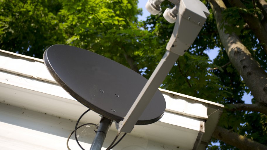 Television cable dish installed on home with service cables