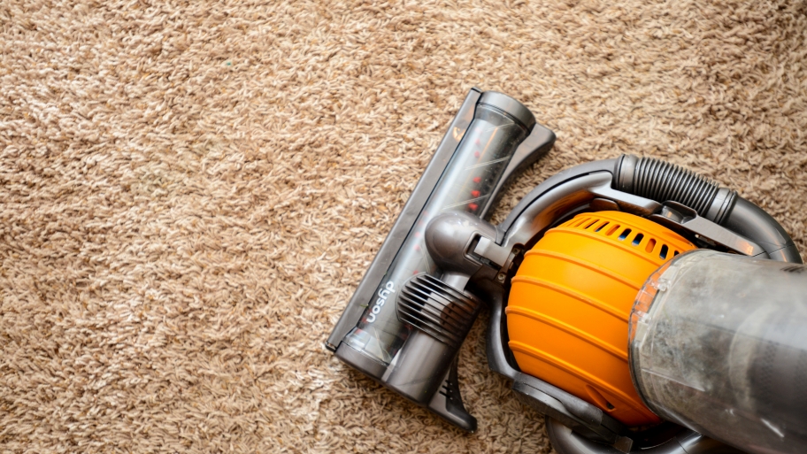 dyson vacuum cleaner on tan, shag carpet