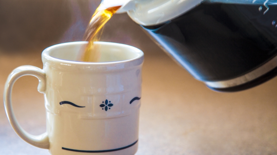 coffee pouring from a pot into a cup