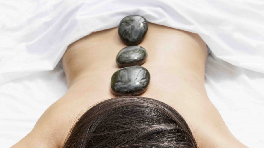 woman getting a hot stone massage