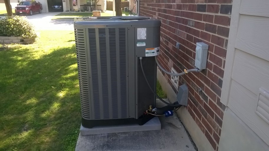 air conditioner beside brick house