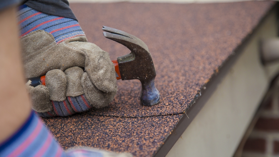 roofer working on asphalt roof