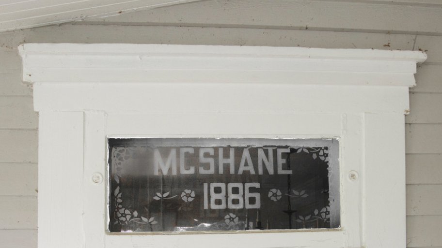Glass sign atop entryway door at McShane House in Carmel, Indiana