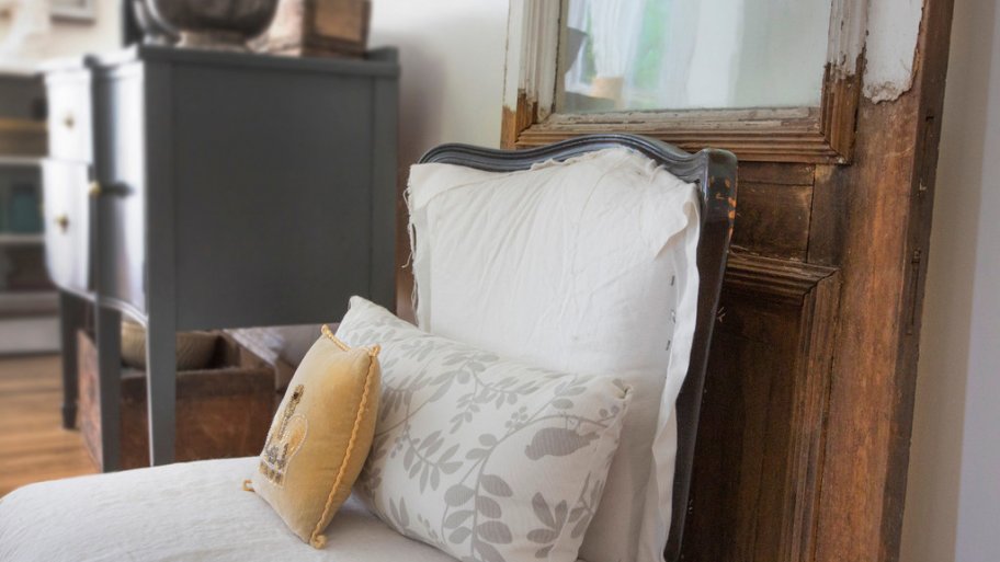 Chair with pillows and a wood door at McShane House in Carmel, Indiana