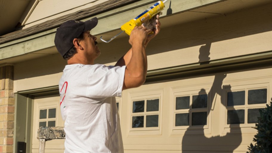 caulking gutter with caulk gun