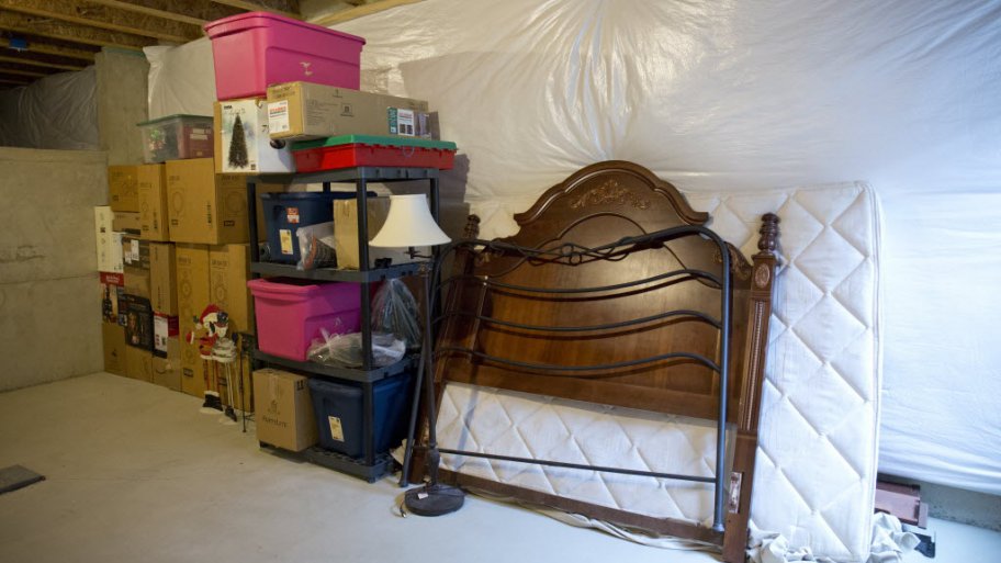 Moving boxes, totes and tubs stacked in a basment