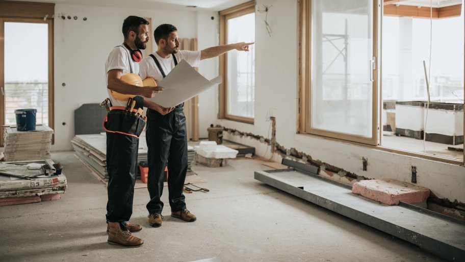 remodelers observing their blueprints/plans for a mutliple room remodel