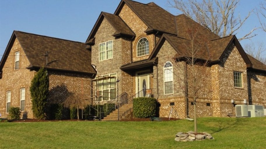 two-story brick home with new roof