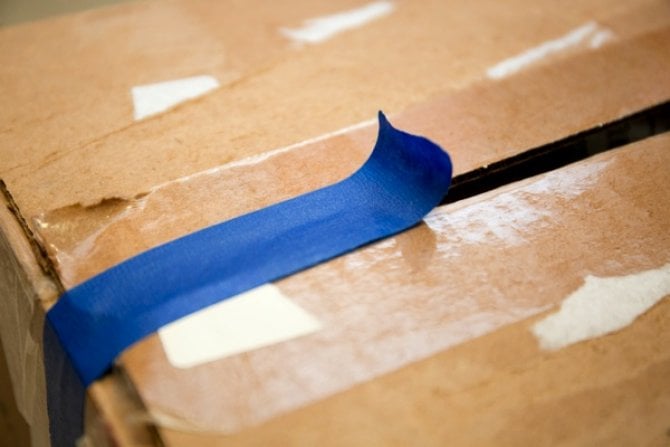 a cardboard box with blue packing tape
