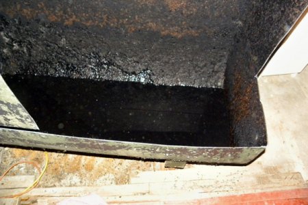 Even when a fuel oil tank has been pumped, about 5-10 gallons of sludge and oil will remain in the tank after pumping, says Gorman. (Photo courtesy of Timothy Gorman Contractor)