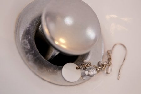 Before calling a plumber, there are steps you can take to try to retrieve lost jewelry from a drain. (Photo by Eldon Lindsay)