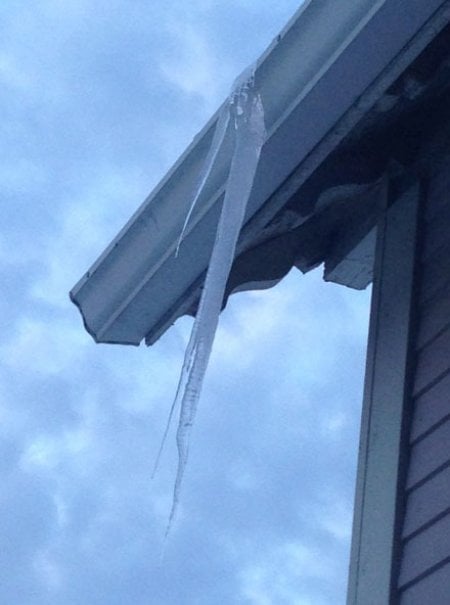 long, pointy icicle hanging from gutter