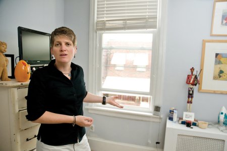 homeowner standing in front of screwed-shut window