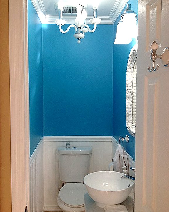 bathroom remodel with blue walls and wainscoting