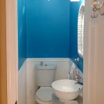 bathroom remodel with blue walls and wainscoting
