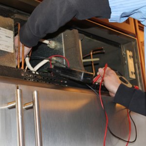 all american appliance repair an all american appliance employee checks condenser fan motor while repairing customers refrigerator repair maintenance guide angies list all american appliance repair an all american appliance employee checks condenser fan motor while repairing customers refrigerator repair maintenance guide angies list