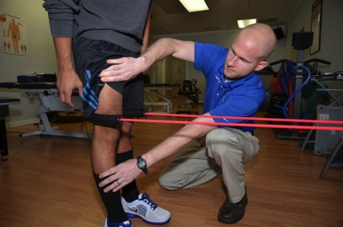Physical therapist Ryan Whelton, owner of Sport and Spine Physical Therapy and Wellness Center in Tampa, helps patient Jose Manzo rehab his knee following ACL reconstruction. (Photo by Dennis Gregg)