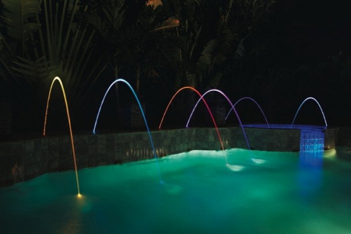 A feature gaining popularity is Pentair's MagicStream Laminars, which produce an arc of water illuminated by LED lights. (Photo courtesy of Pentair Aquatic Systems)