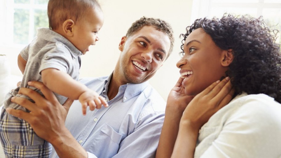 Young Family Playing With Happy Baby Son At Home. (Photo by Monkey Business Images)