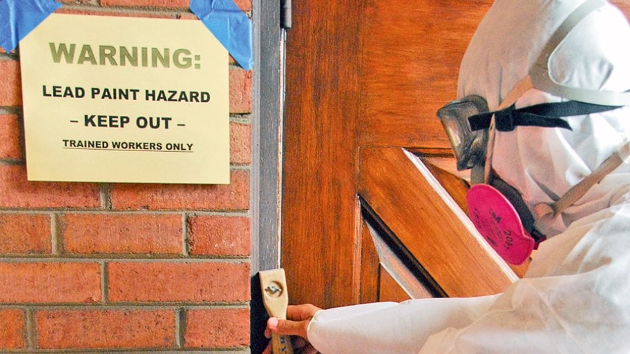 man checks lead paint