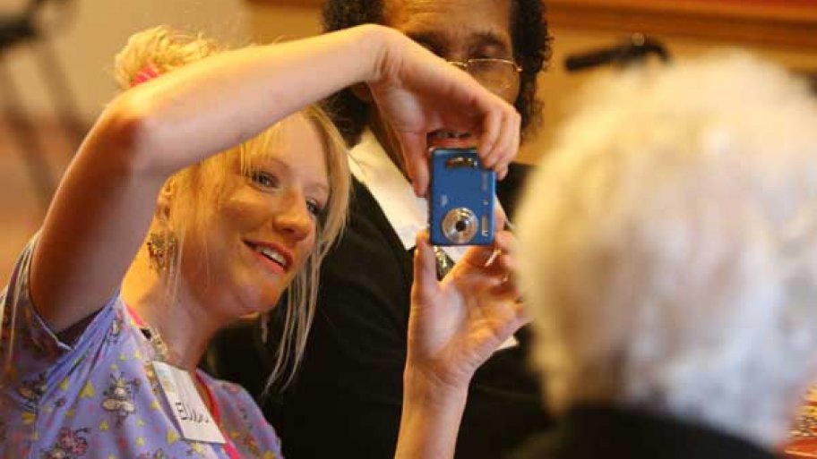 nursing home worker takes a photo of residents.
