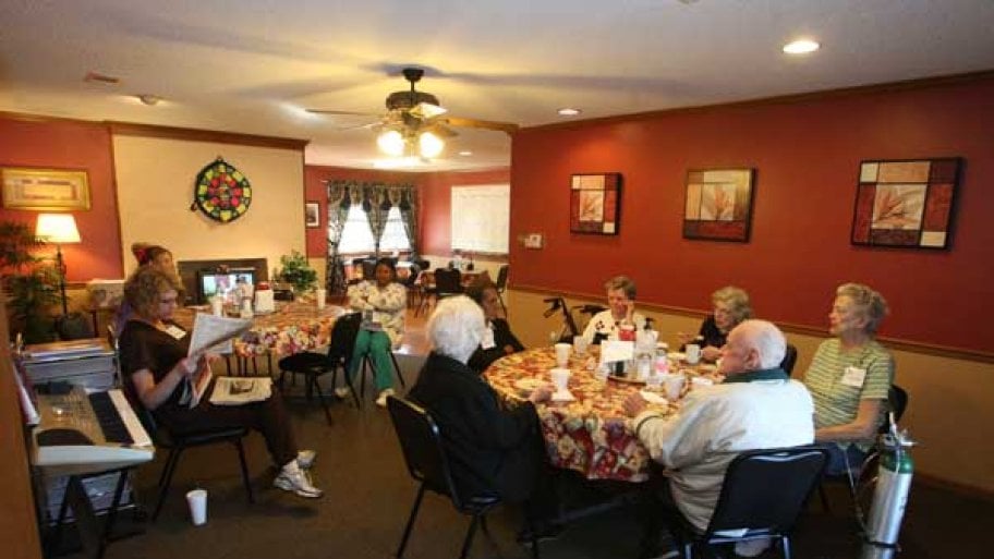 Nursing home residents sitting at table for a holiday meal.