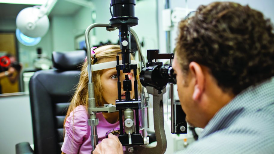 pediatric eye doctor examines 6-year-old girl