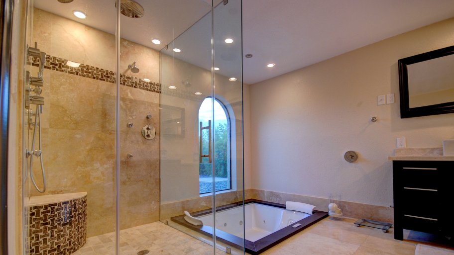 remodeled bathroom with jacuzzi tub, multiple shower heads tile