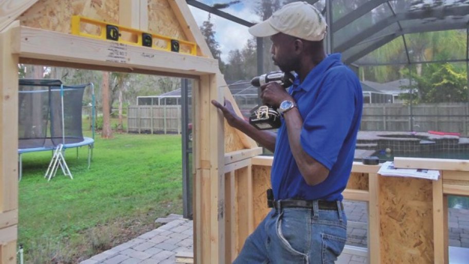 Troy Johnson putting up a garden cottage
